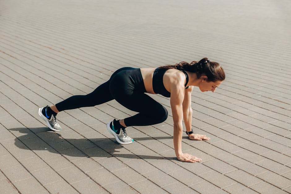 Woman in black sportswear doing an outdoor workout on a sunny day