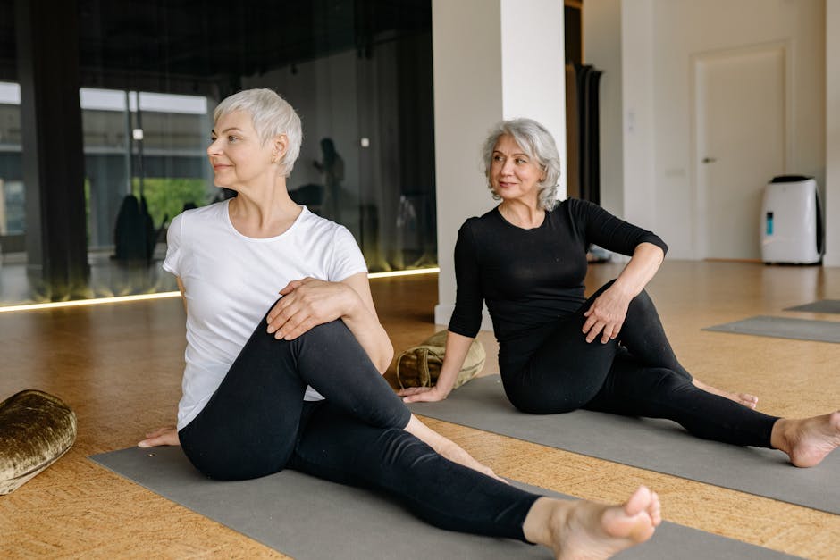 Two senior women enjoying yoga, focusing on wellness and flexibility indoors