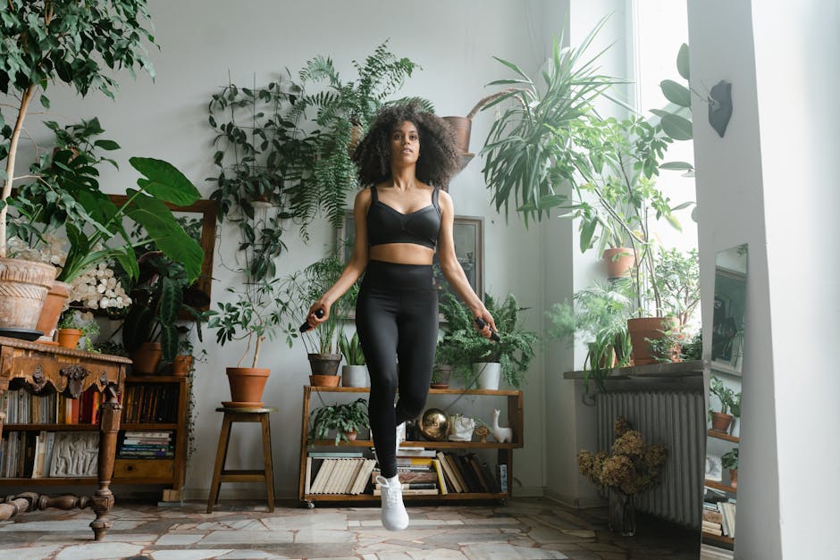 African American woman jumping rope in a plant-filled room, promoting a healthy lifestyle